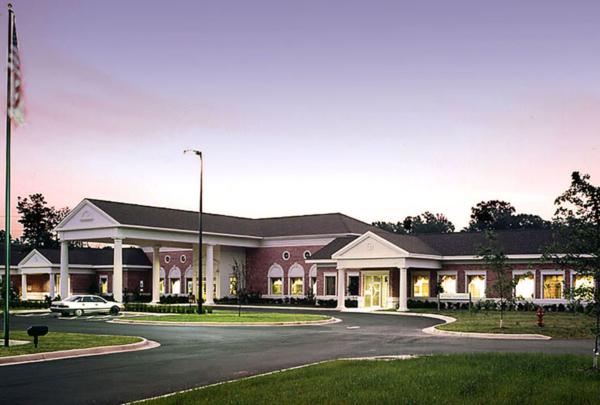 Exterior photo of Healthpark Hospital entrance at dusk.