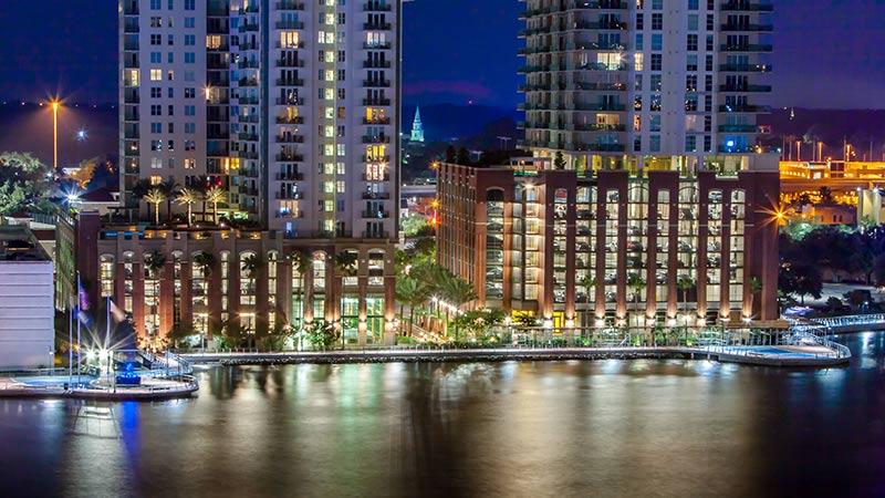 Building lights at night reflecting on the river.