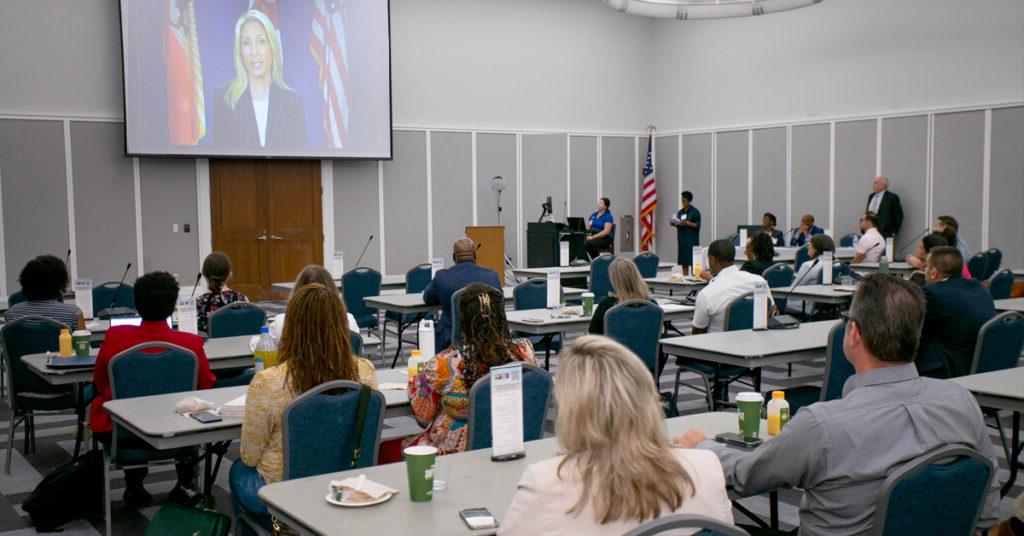 Participants in the task force working on the Creating Safe Spaces and Vision Zero Action Plans listen as Jacksonville Mayor Donna Deegan addresses their meeting.